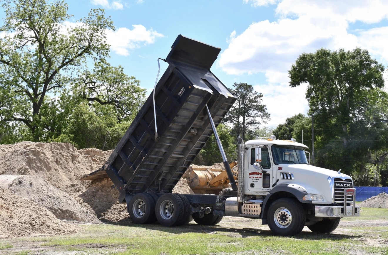 Dump truck delivering fill material at job site