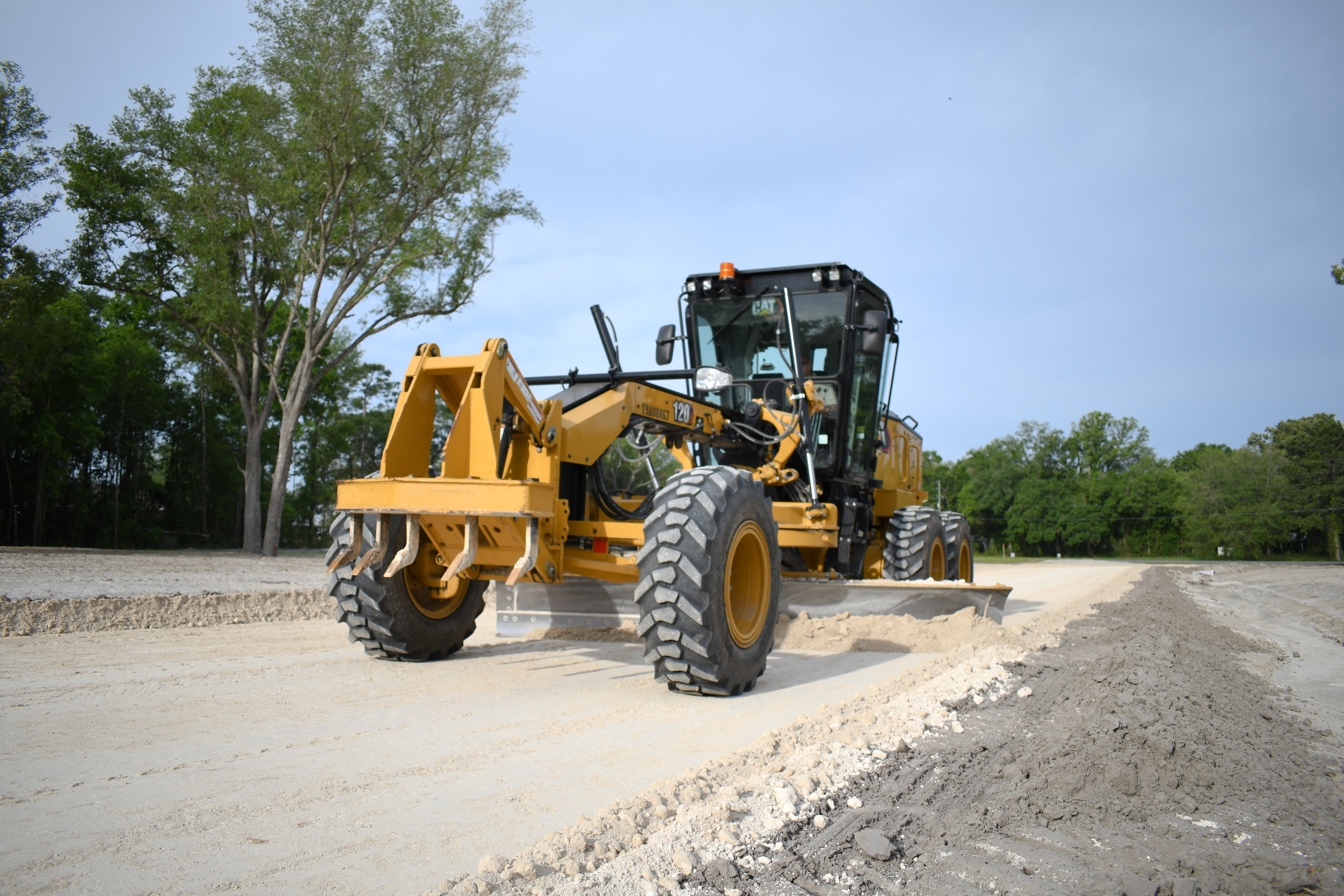 CAT motor grader performing precision road grading