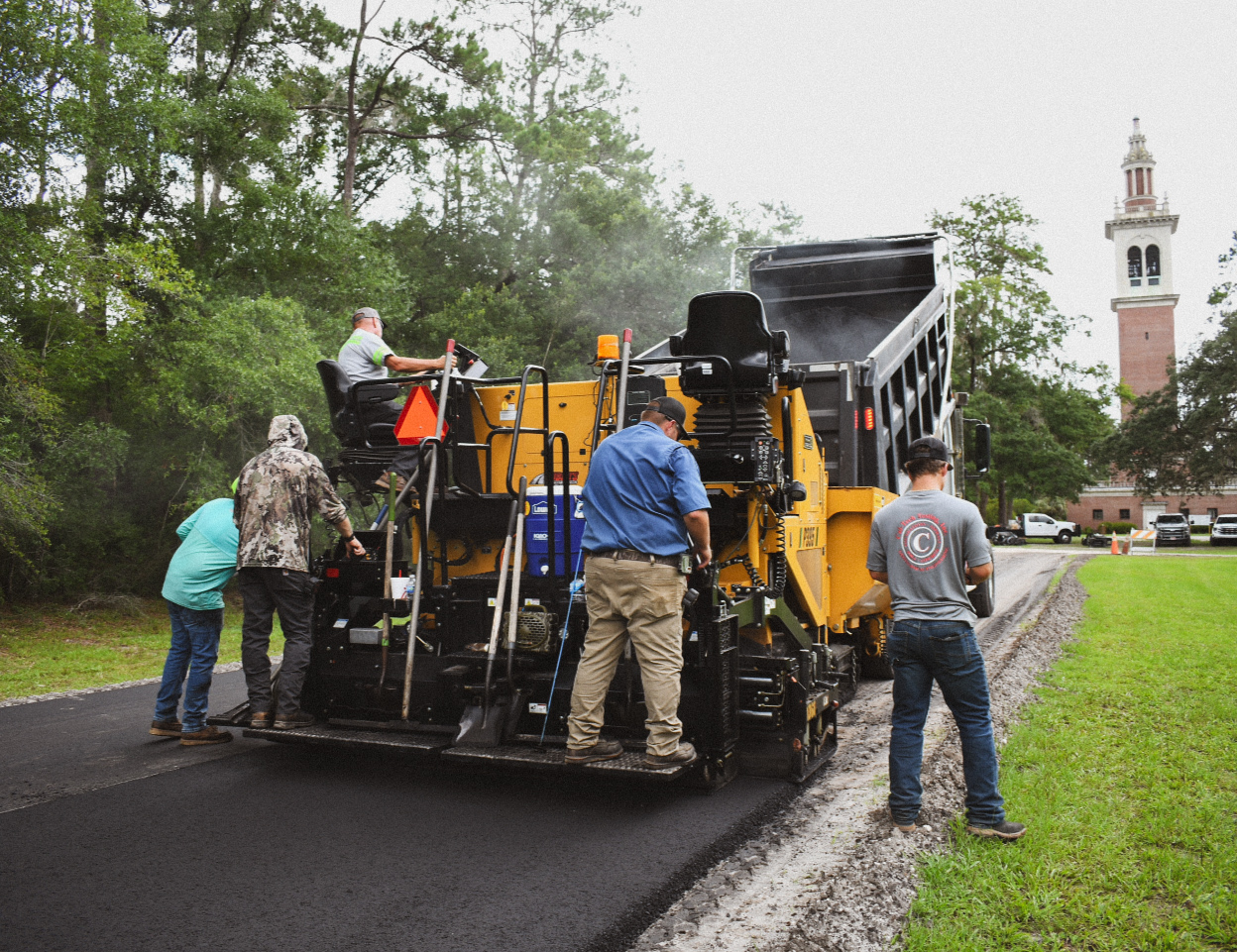 Asphalt paving crew working on campus paving project in North Florida